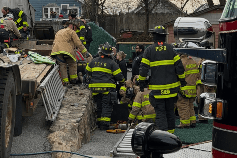 Truck Driver Pinned Under His Own Lowboy Trailer After Brakes Unexpectedly Release During Roadside Inspection — Firefighters Deploy Airbags and Bottle Jacks to Rescue Him