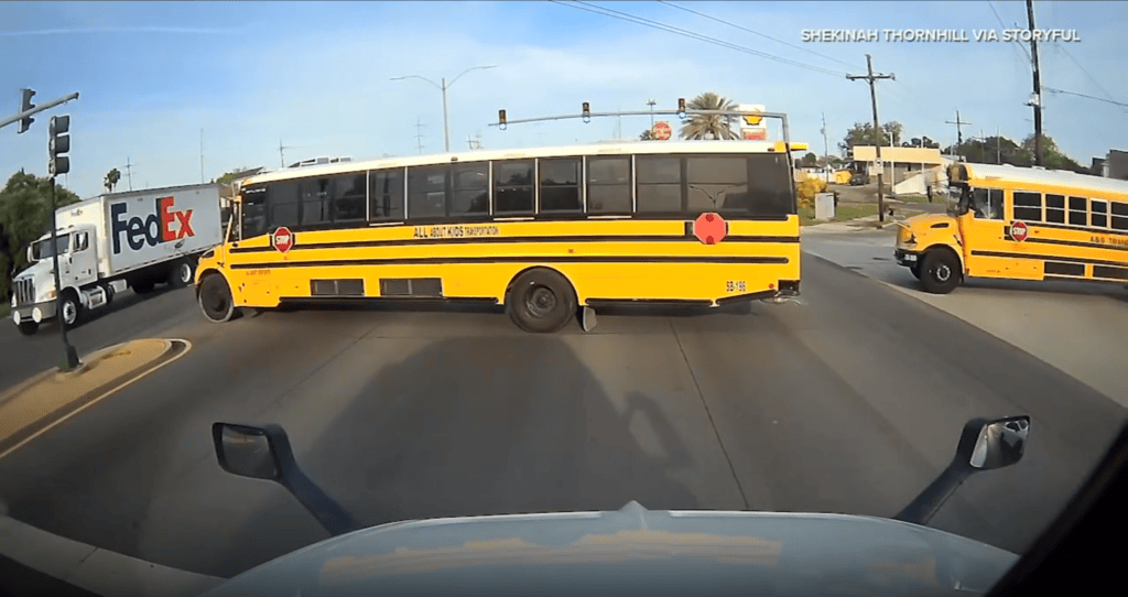 School Bus Runs Red Light in Front of Semi