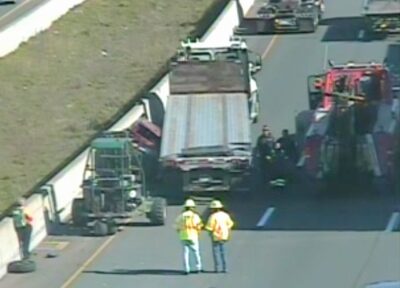 Driver Pinned Between Tractor-Trailer and Traffic Barrier